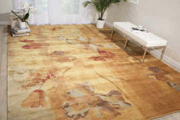 Bright room scene with a Nourison Somerset Beige Farmhouse Area Rug featuring large floral patterns and a white bench.