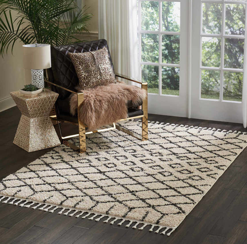 Living room scene with a Nourison Moroccan Shag Cream Tribal rug, gold chair, and dark wood floors.