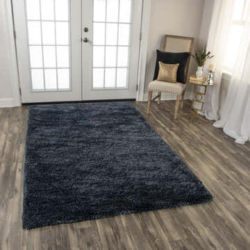 Living room scene with charcoal Rizzy WIS101 shag rug, wood floors, white doors, chair, and gold accent table. Roomscene-Rectangle