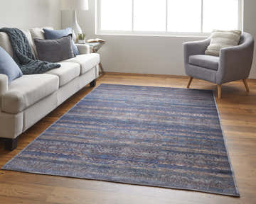 Living room scene with a Feizy Voss blue/purple/brown geometric rug, sofa, and gray armchair. Roomscene-Rectangle