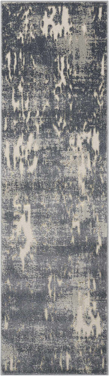 Close-up of the Michael Amini Gleam Slate rug. Modern design with taupe, gray, and cream abstract pattern. Soft polyester texture.