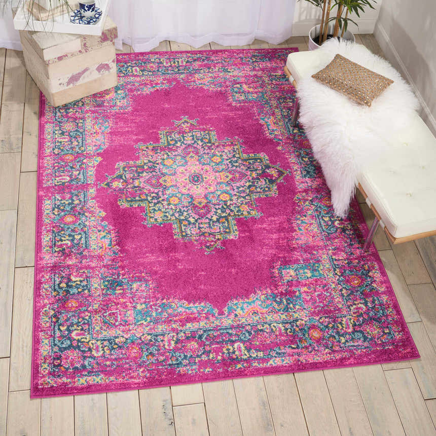 Bright room scene with a Nourison Passion Fuchsia rug, white bench with fur throw, and light wood floors. Bohemian style.