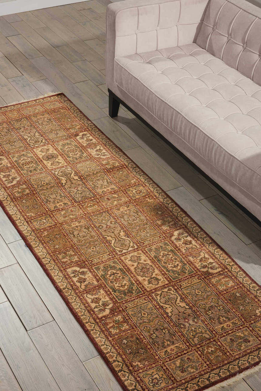 Living room scene with a beige sofa and Nourison Legend Multicolor Persian rug on a wood floor.
