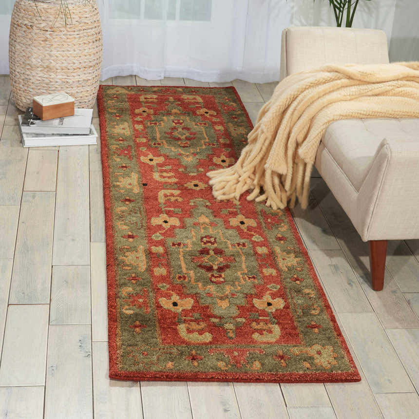 Living room scene with a Nourison Tahoe Rust rug, beige bench, and light wood floors.