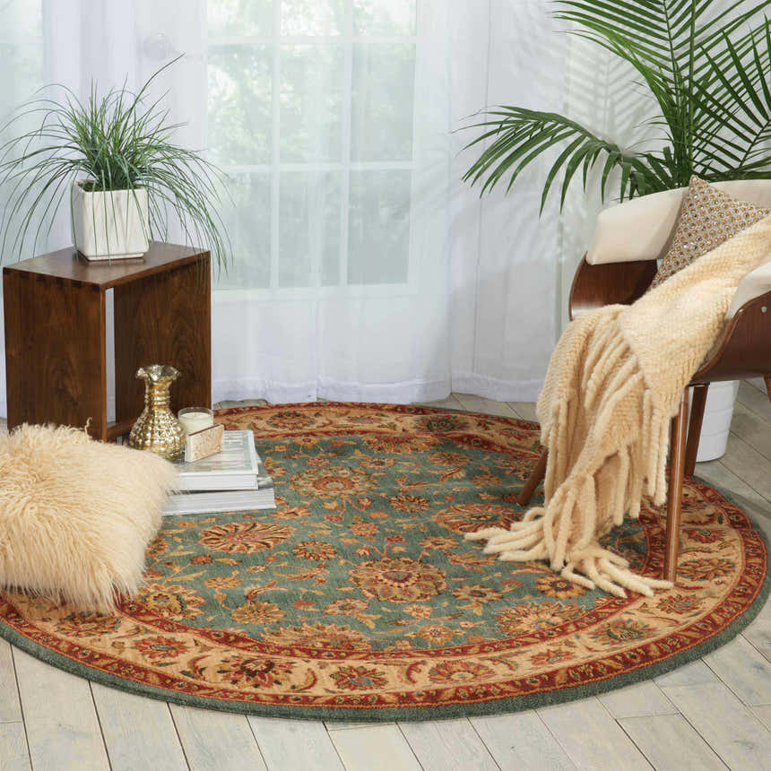 Living room scene with aqua Nourison Living Treasures rug. Round rug features traditional floral pattern in aqua, red, and beige.