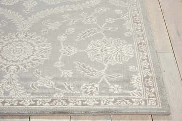 Close-up of Nourison Luminance Ironstone rug showing vintage floral pattern, soft ironstone color, and textured wool blend.