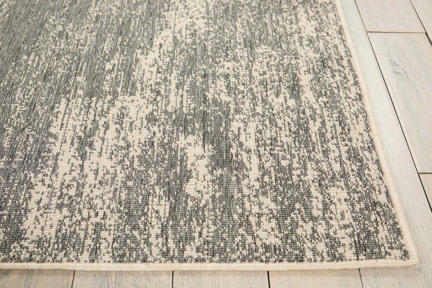 Close-up of the Barclay Butera Lido Grey Cream rug showing its abstract pattern and texture on light wood flooring.