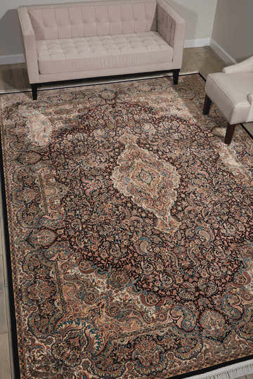 Living room with beige sofa and Nourison Persian Palace Navy Persian Rug, showcasing its intricate floral and paisley design.