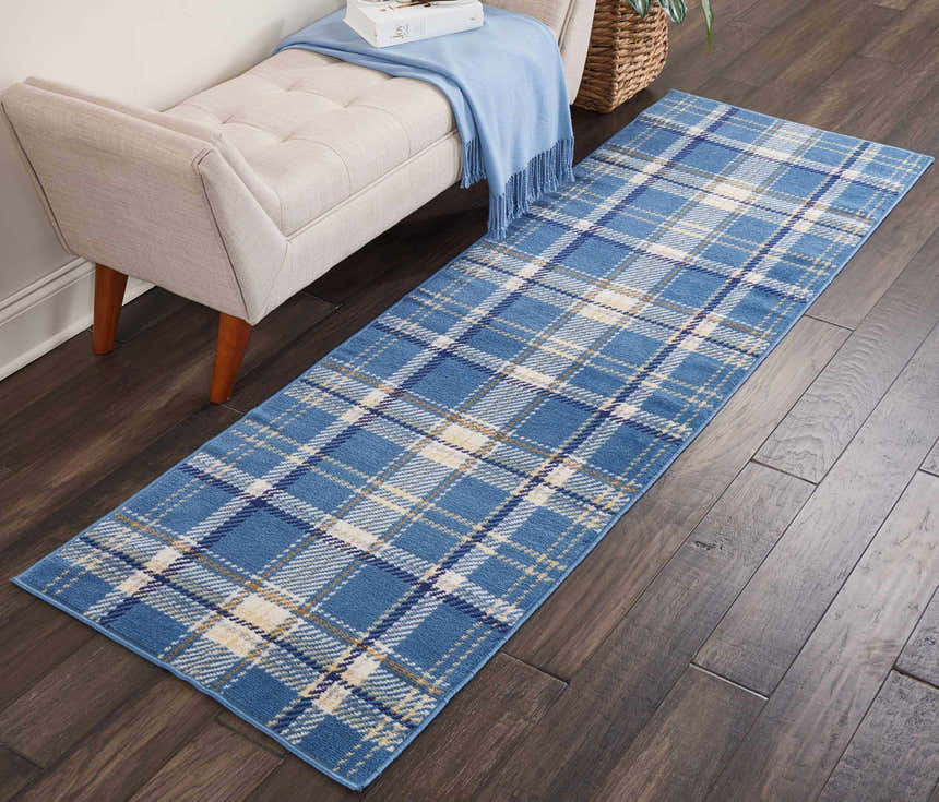 Entryway with a light beige bench and Nourison Grafix Blue Rustic runner rug on dark wood floors.