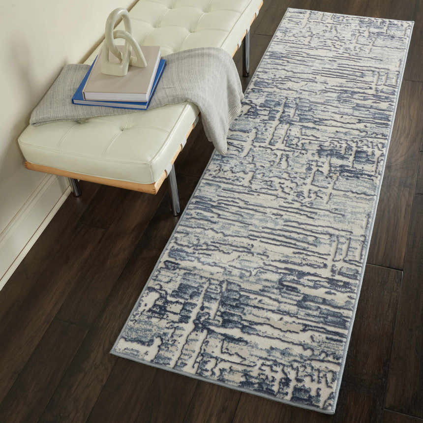 Hallway scene with Nourison Urban Chic Ivory runner rug, white leather bench, and dark wood floors.
