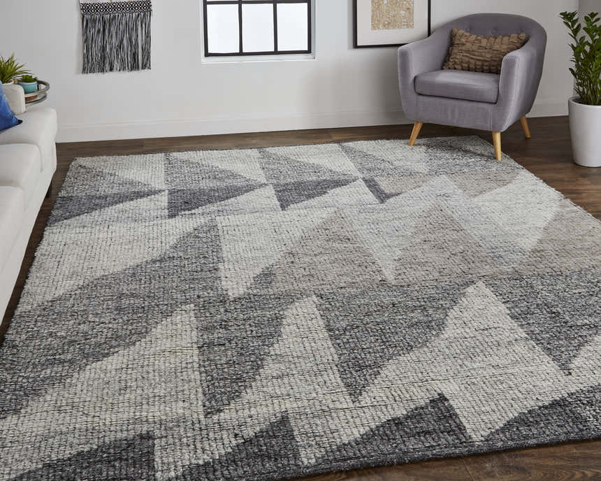Living room scene with a Feizy Alford ivory, gray, and taupe geometric wool rug, white sofa, and gray chair. Roomscene-Rectangle