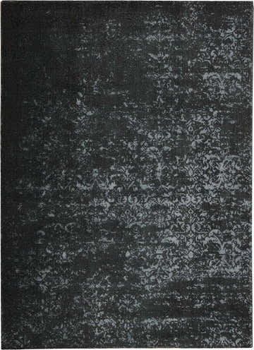 Close-up of the Calvin Klein Home Maya Midnight rug, featuring a subtle floral pattern in shades of black and gray.