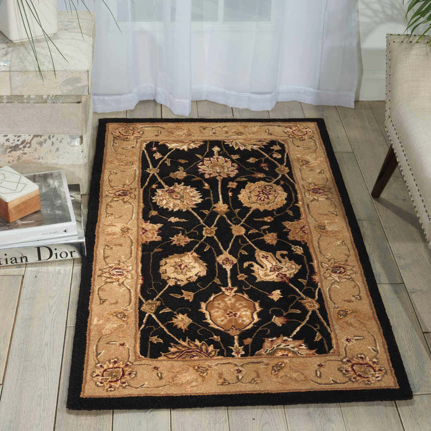 Living room scene with Nourison 3000 Black Persian rug, floral design, black border, and beige accents on wood floor.