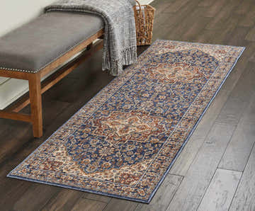 Entryway with bench and Nourison Lagos Blue Persian runner rug on dark wood floor.