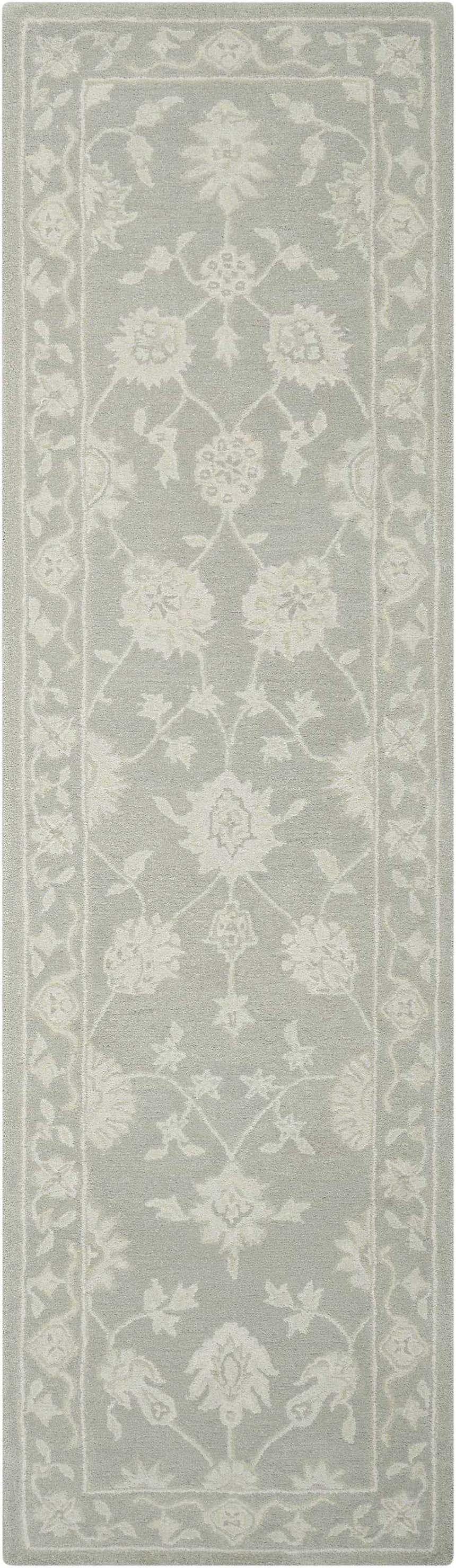 Close-up of the Nourison Zephyr Light Taupe rug. Features an ivory floral pattern and border on a light taupe wool texture.