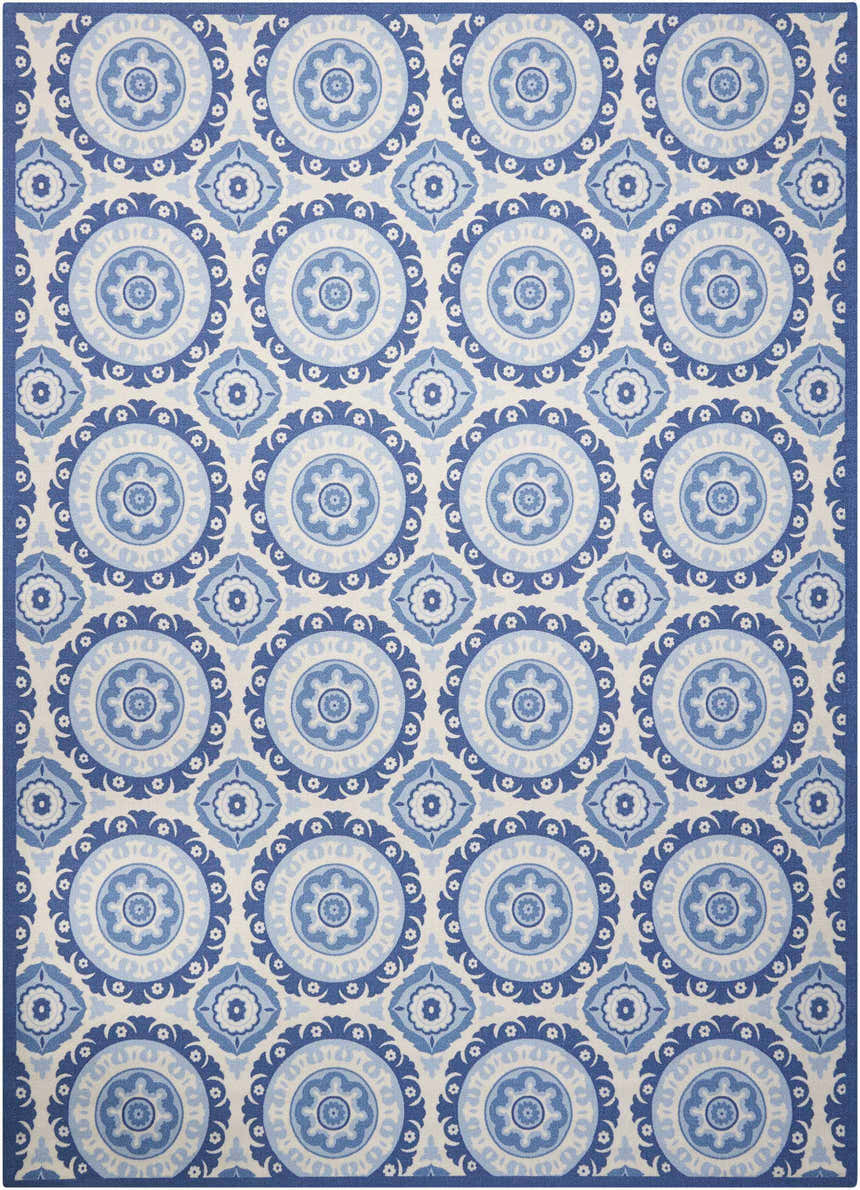Close-up of Waverly Sun N' Shade Navy rug. Coastal style with blue floral medallion pattern on a light background.