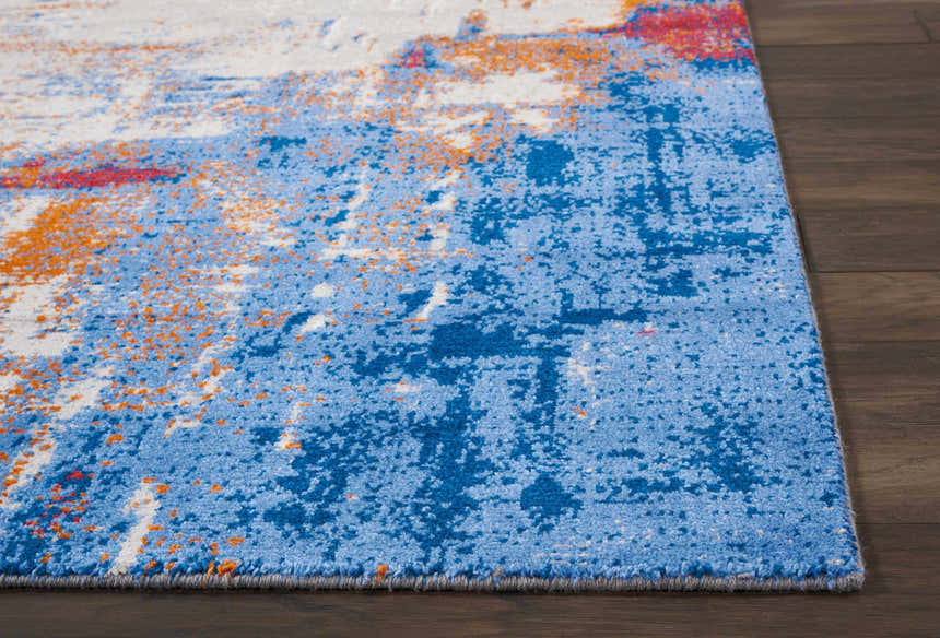 Close up of Nourison Twilight Ivory Multicolor Rug showing blue, orange, and white abstract pattern.