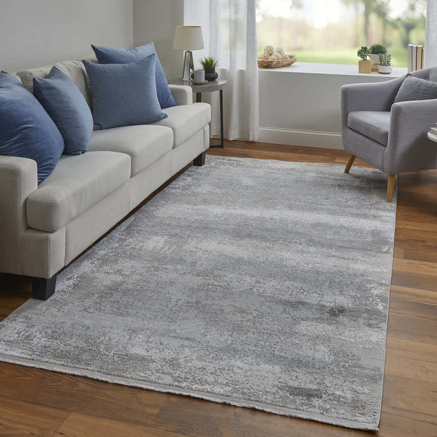 Living room scene with a Feizy Cadiz Taupe/Gray/Silver Area Rug, sofa, armchair, and wood floors. Roomscene-Rectangle