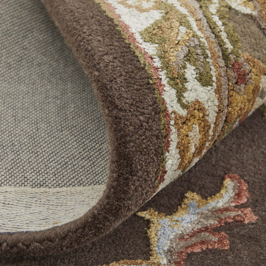 Close up of the Feizy Prescott rug showing the brown, ivory, and tan traditional floral pattern. Fold