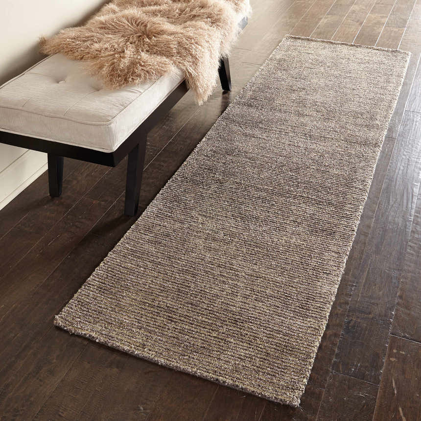 Hallway scene with a Nourison Weston Charcoal runner rug, taupe bench, and dark wood floors.