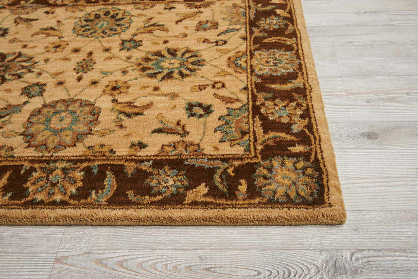 Close-up of the Nourison Living Treasures Beige rug, showcasing its traditional floral pattern and brown border on light wood floor.