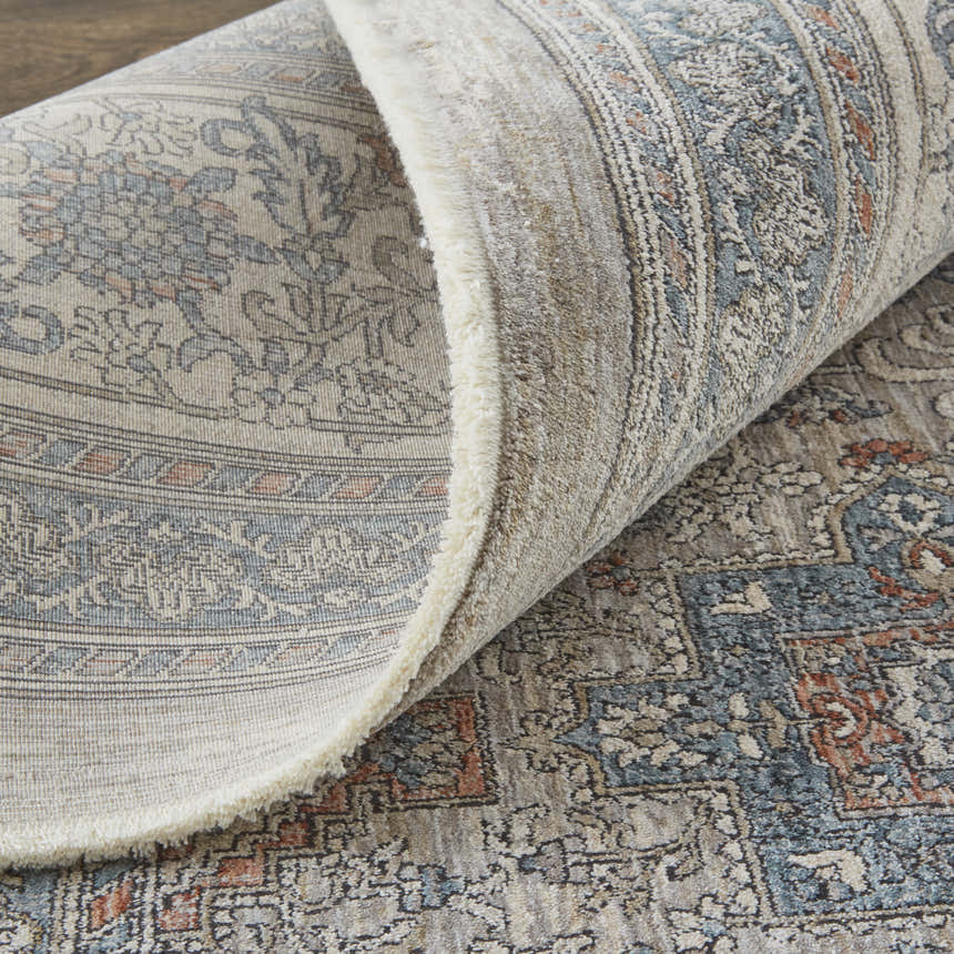 Close-up of Feizy Marquette Taupe/Silver/Blue Area Rug showing its transitional oriental pattern and soft, textured pile. Fold