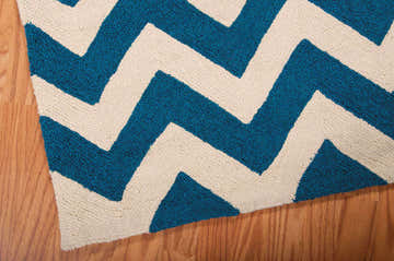 Close up of the Nourison Portico Navy Colorful Area Rug with a bold chevron pattern.