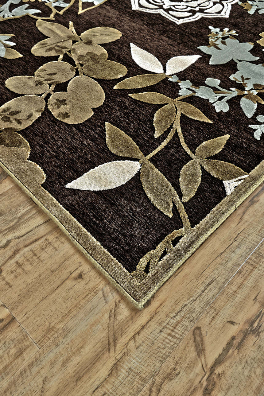 Close-up of Feizy Saphir Mah rug. Brown rug with ivory, green floral and botanical design. Casual, farmhouse style. Corner