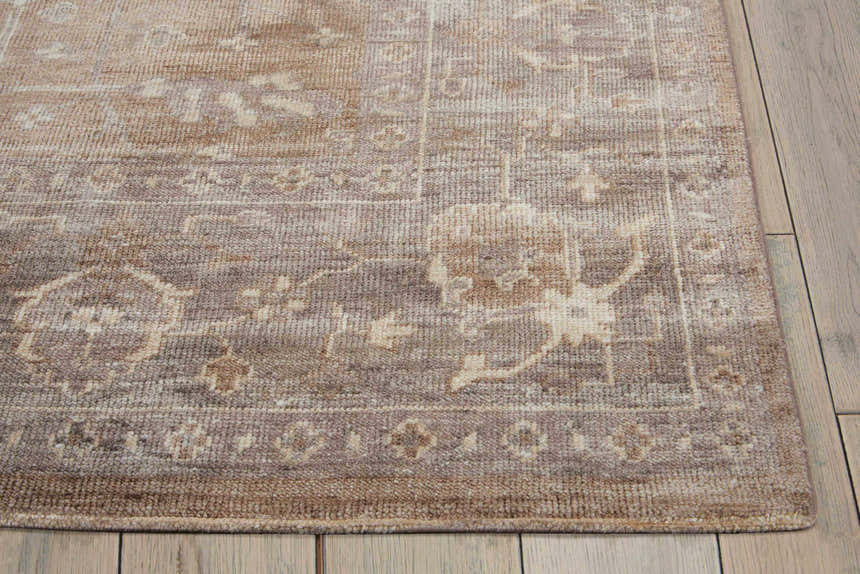 Close-up of the handmade Nourison Aldora Pewter Vintage Area Rug showing its gray, brown, and beige vintage pattern.