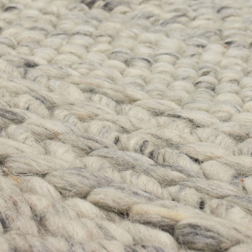 Close-up of the hand-loomed Karastan Zaza Ivory Area Rug, showing its dim gray and ivory wool texture. Texture