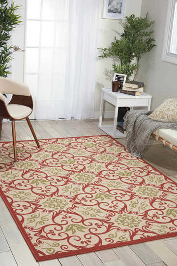 Bright living room with Nourison Caribbean Ivory Rust rug, a chestnut floral pattern on a cream background.