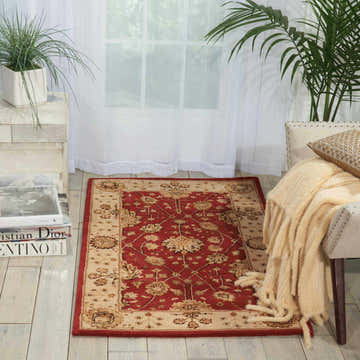 Living room scene with a Nourison 3000 Red Persian rug, light wood floors, white curtains, and neutral furniture.