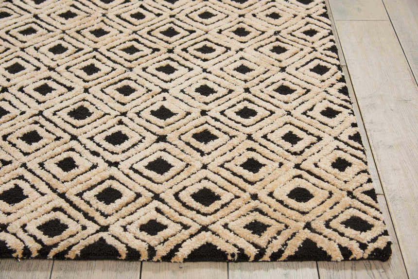 Close-up of the Nourison Deco Mod Black Beige rug, featuring a geometric diamond pattern and textured polyester pile.