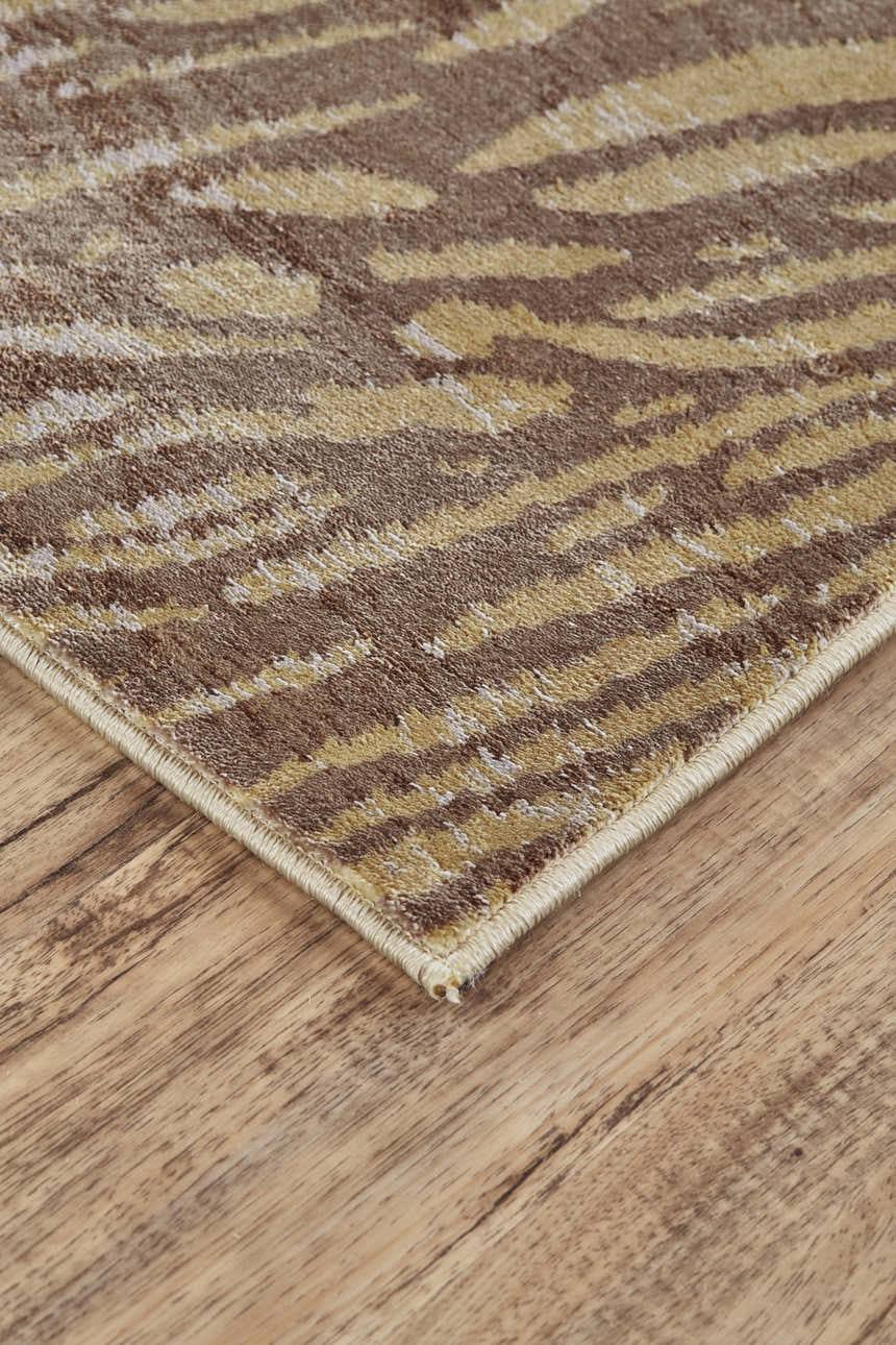 Close up of the Feizy Cannes Brown/Tan rug showing its animal print pattern and jute backing. Corner