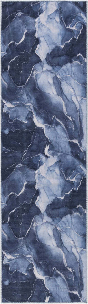 Close-up of Daydream Navy Blue rug. Modern design in shades of blue with white accents, resembling marble. Washable area rug.