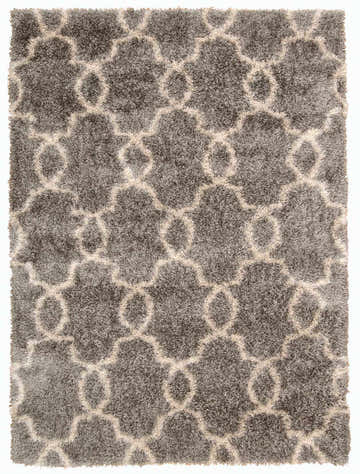 Close-up of the Nourison Escape Silver Shag rug. Features a silver gray shag texture with a cream-colored geometric pattern.