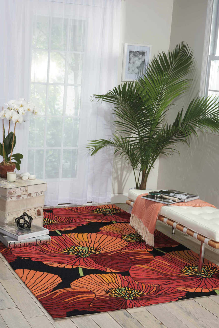 Bright living room with Nourison Fantasy Black rug featuring large red and orange floral pattern.