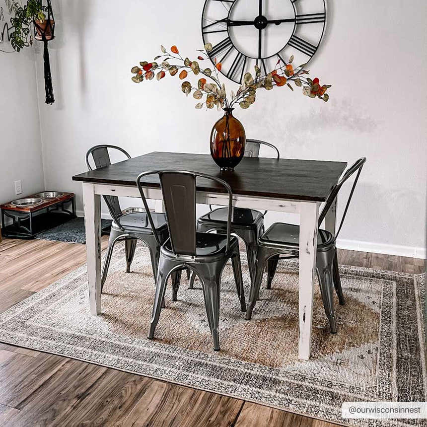 Farmhouse dining room with dark wood table and Albas Washable Area Rug in light brown and blue tones. Roomscene-Rectangle