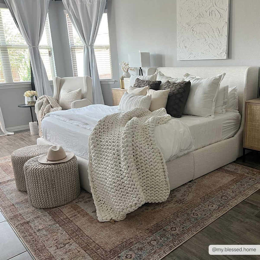 Bedroom scene with a neutral palette and the Analu Non-Slip Washable Rug in brown, red, and blue tones. Roomscene-Rectangle