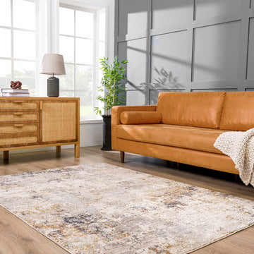 Living room scene with a Sten Area Rug, tan leather sofa, and light wood cabinet. Roomscene-Rectangle