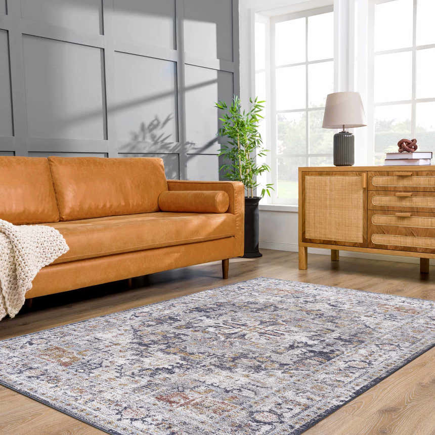 Living room with tan sofa and Ivria Navy & Rust Area Rug. Farmhouse style with light gray walls and wood accents. Roomscene-Rectangle