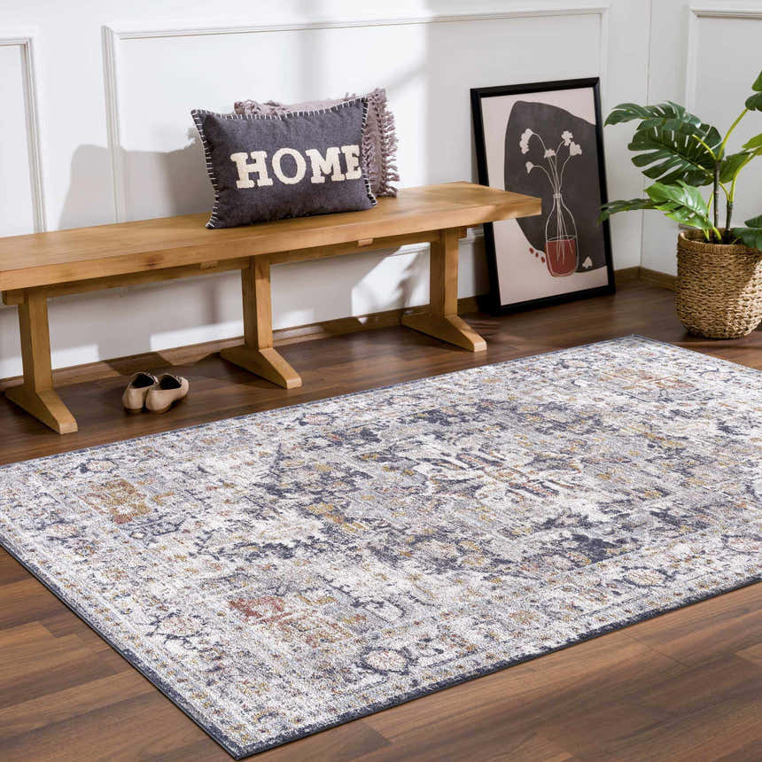 Entryway with wood bench, plant, and Ivria Navy & Rust Area Rug on wood floor. Farmhouse style. Roomscene-Rectangle
