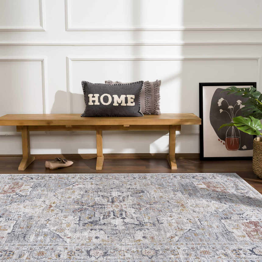 Entryway scene with a wood bench, pillows, and the Ivria Blue Gray Area Rug adding a farmhouse touch. Roomscene-Rectangle