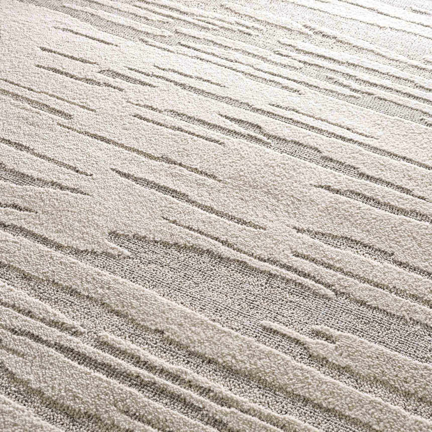 Close-up of the Lave Bone Area Rug showing its textured, tone-on-tone, linear design in shades of bone and light gray. Texture