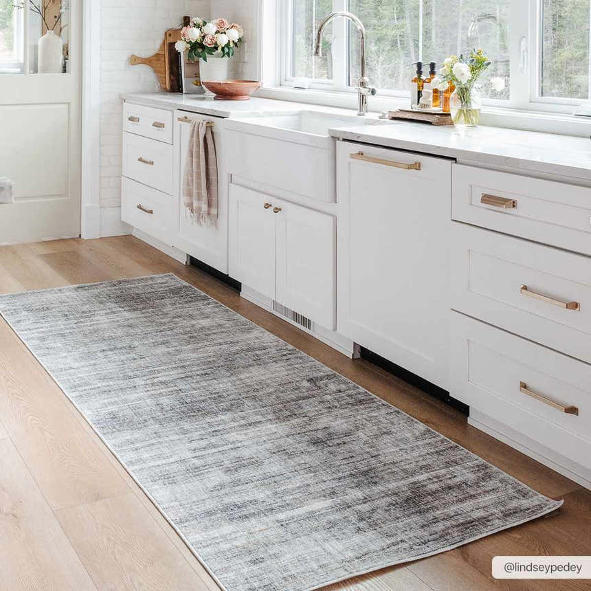 Braxton Carved Statement Area Rug in a bright white kitchen. Gray runner rug on wood floor. Modern farmhouse style. Roomscene-Runner
