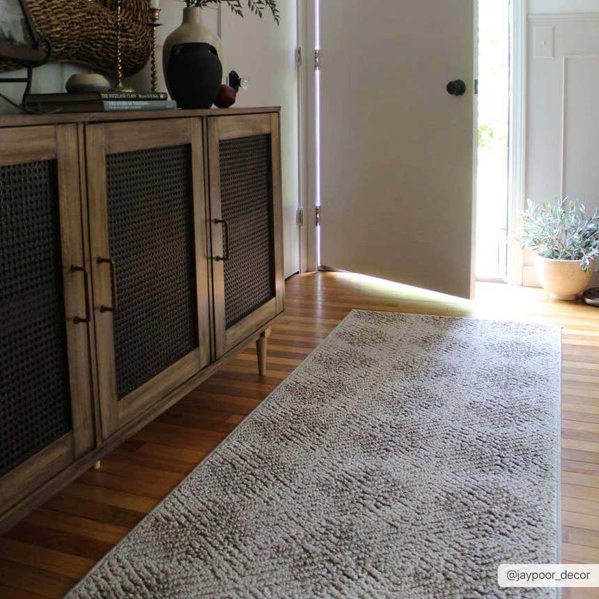 Entryway with a Broox Beige runner rug, wood floors, console table, and an open door letting in natural light. Roomscene-Runner