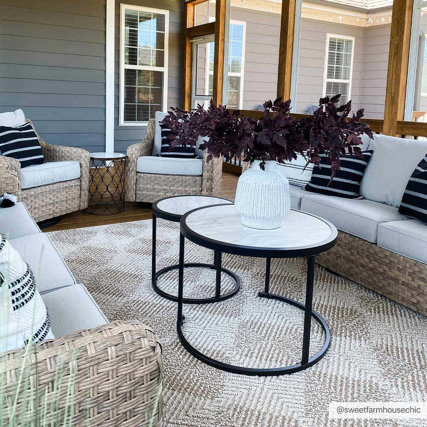 Screened porch with wicker furniture and Broox Beige Area Rug. Neutral tones and black accents create a modern farmhouse style. Roomscene-Rectangle