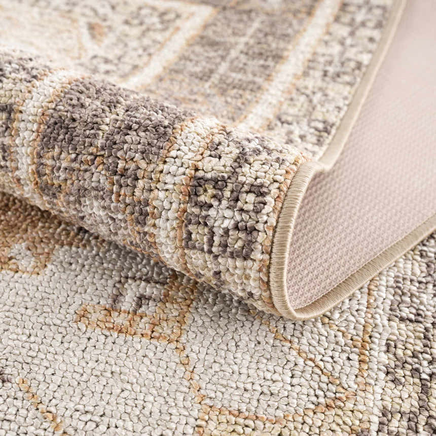 Close-up of the Albas Washable Area Rug showing its texture, pattern, and colors: dark brown, light brown, and light blue. Fold