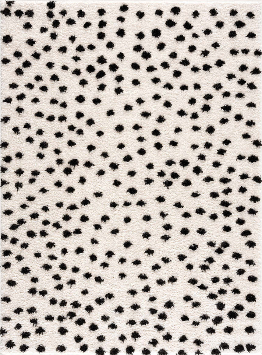 Close-up of the Cansu Black & White Dotted Area Rug. The shag rug has black dots on an off-white background. Design-Rectangle-46