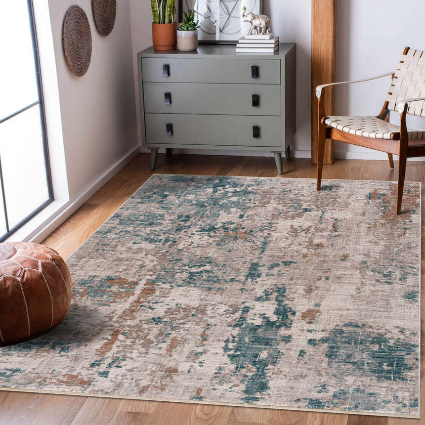 Living room scene with a contemporary Danlugan Area Rug in charcoal, cream, and blue tones. Gray dresser and leather pouf. Roomscene-Rectangle